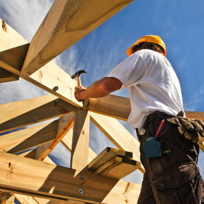 roofer ,carpenter working on roof structure at construction site